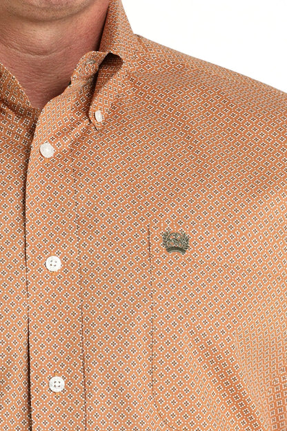 Men's orange geometric patterned button-down shirt with chest pocket and metal badge