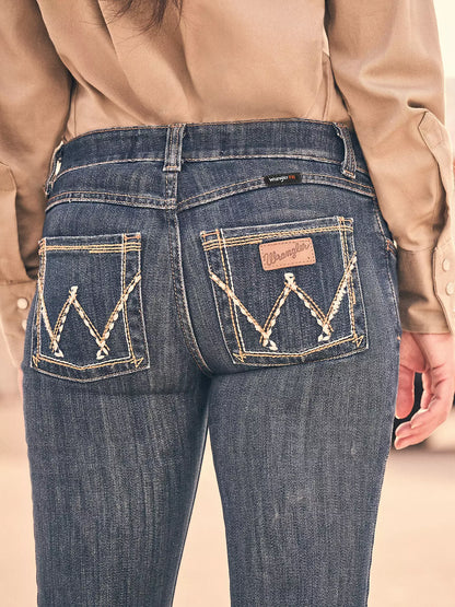 Close-up of woman wearing blue Wrangler FR flame-resistant jeans with stitched back pockets