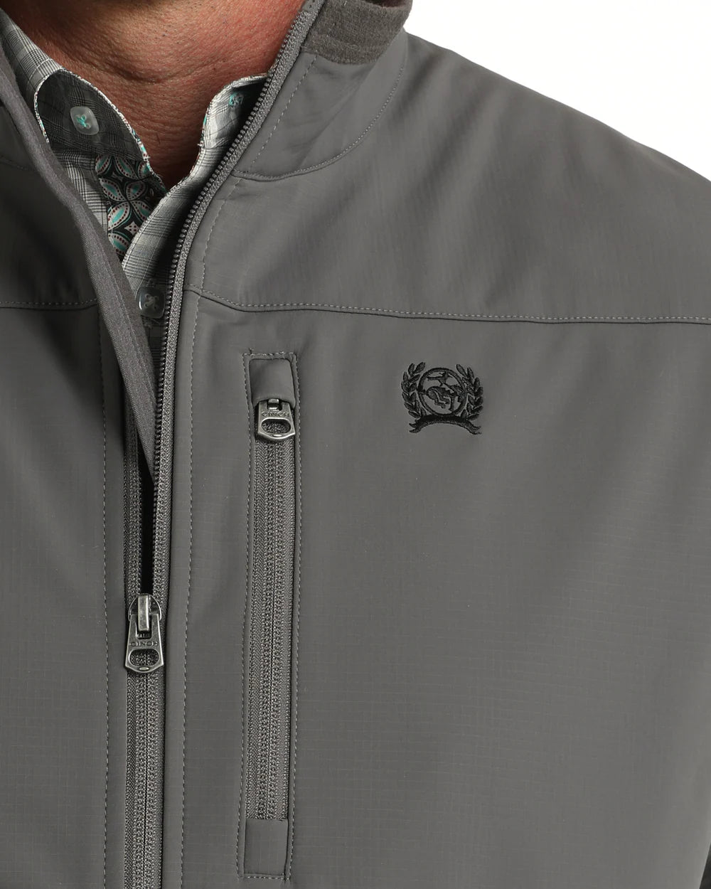 Gray softshell jacket with zip chest pocket, high collar, and embroidered crest logo