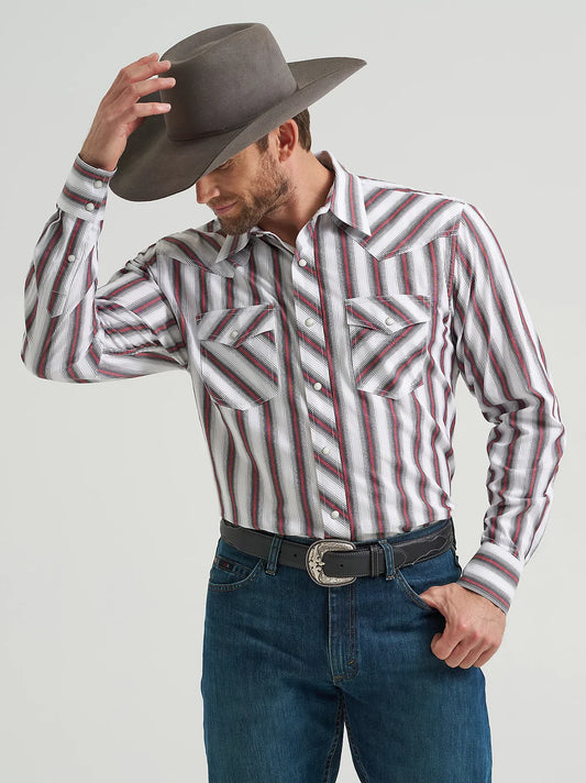 Man in striped western cowboy shirt, denim jeans, and felt hat tipping his hat