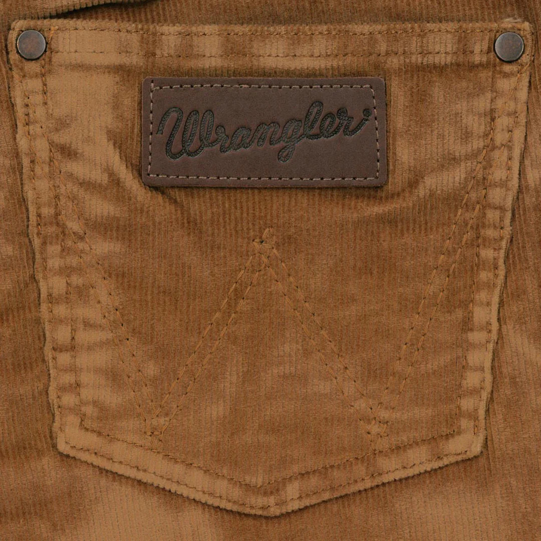 Closeup of brown corduroy back pocket with leather Wrangler label and rivet details