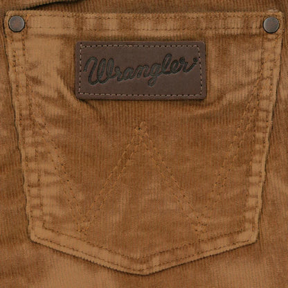 Closeup of brown corduroy back pocket with leather Wrangler label and rivet details
