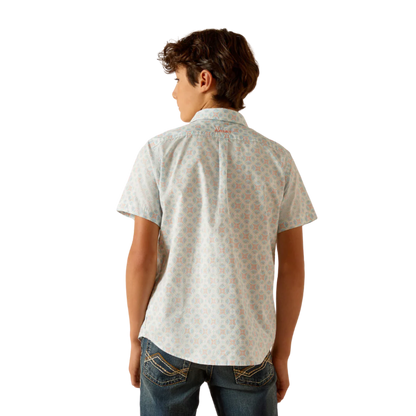 Boy wearing short sleeve patterned button-up shirt and denim jeans, rear view