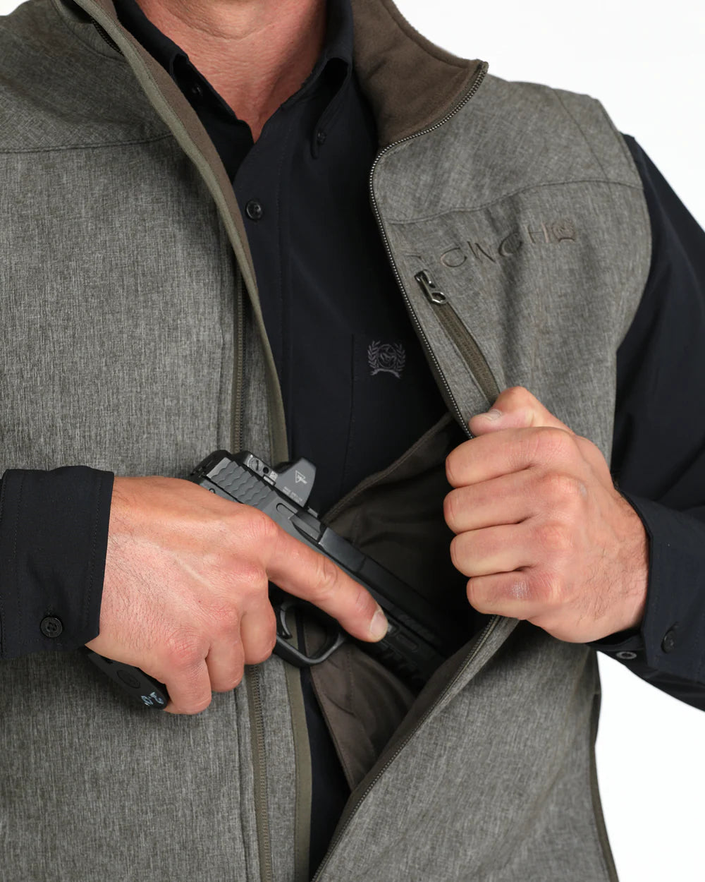 Man drawing a black handgun from concealed carry pocket in gray tactical vest