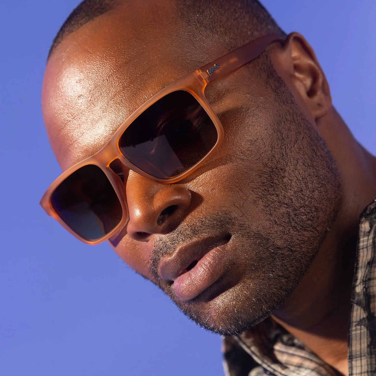 Man wearing sunglasses with a clear blue sky background