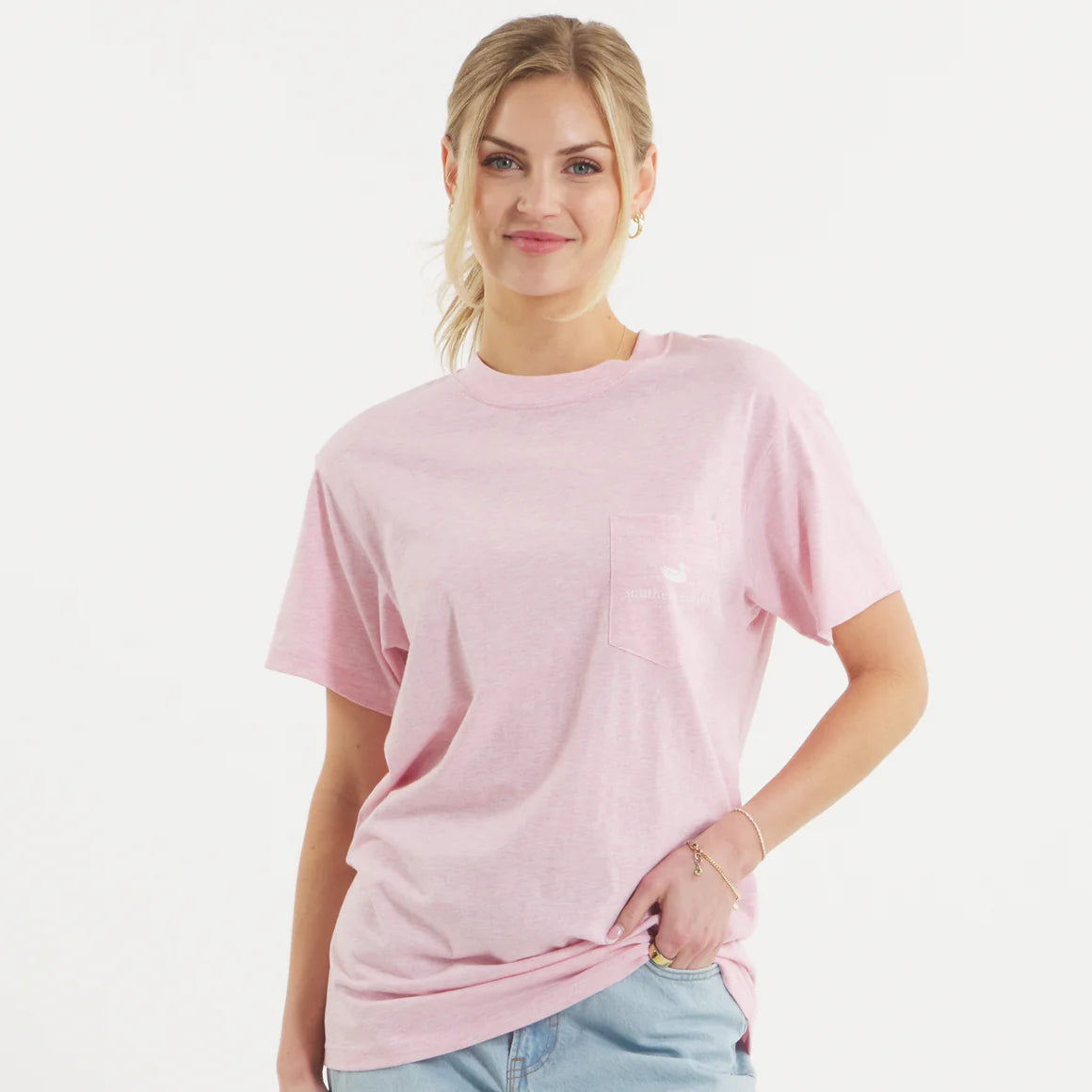Woman wearing light pink pocket t-shirt and light blue shorts on white background