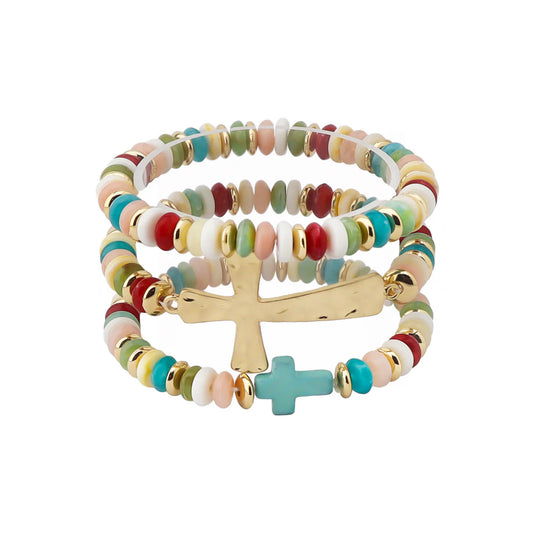 Multicolored beaded bracelet with gold and turquoise cross charms on a white background