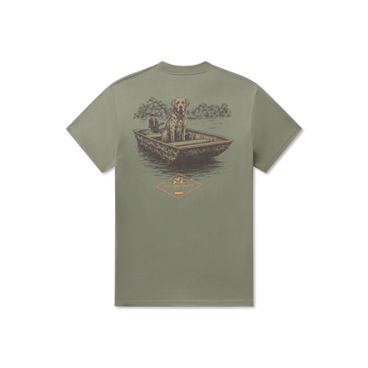 Green t-shirt with a graphic of a dog in a boat on a white background