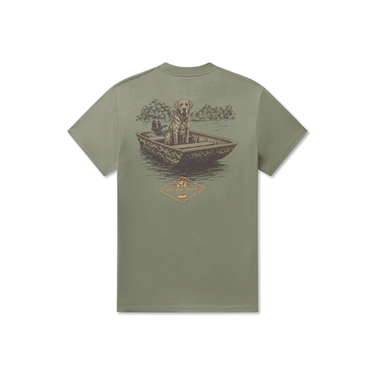Green t-shirt with a graphic of a dog in a boat on a white background