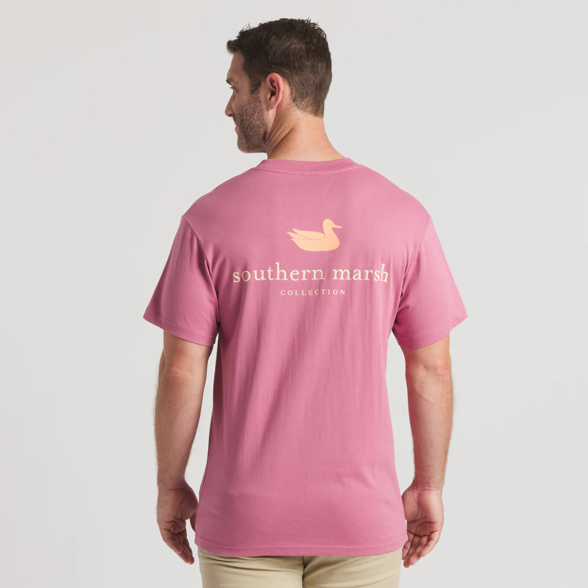 Man wearing pink Southern Marsh Collection t-shirt with duck logo, back view