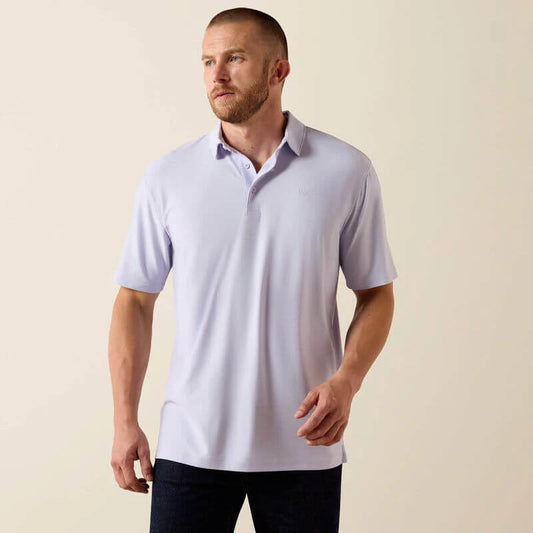 Man wearing a light purple polo shirt against a beige background