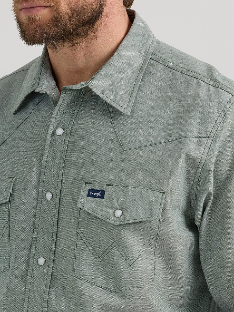 Man wearing light green Wrangler western shirt with snap buttons and chest pockets