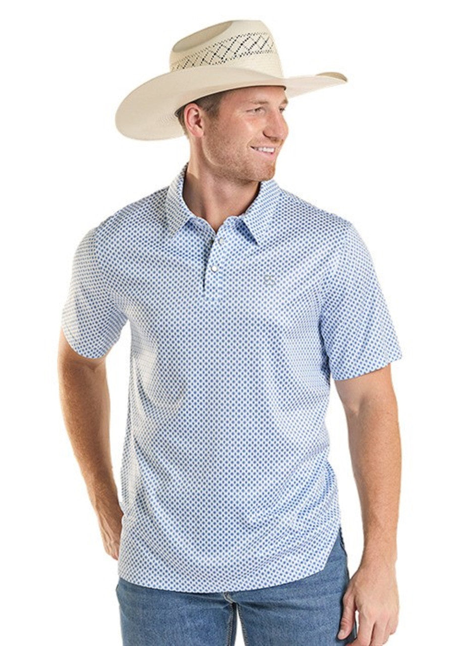 Man wearing a blue patterned shirt and beige cowboy hat on a white background