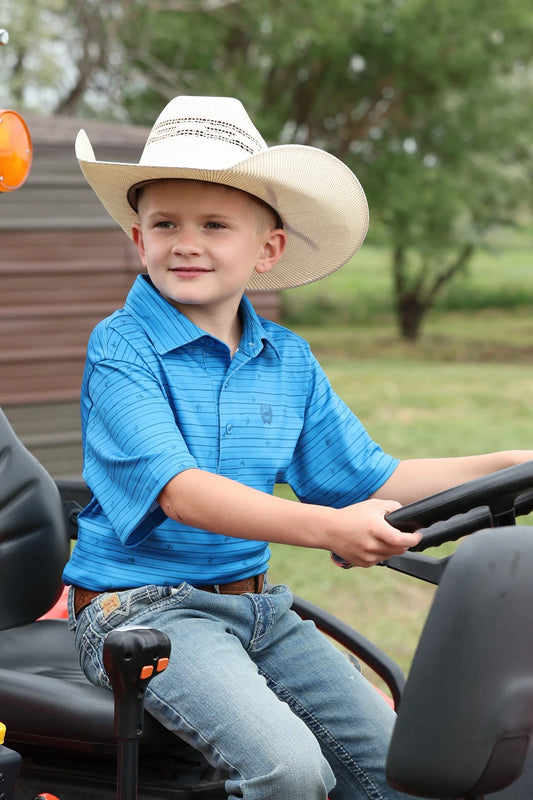 BOY WEARING A BLUE SHIRT ON A TRACTOR
