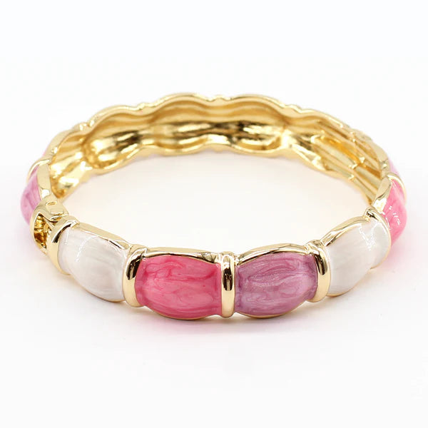 Gold bracelet with pink and white beads on a white background