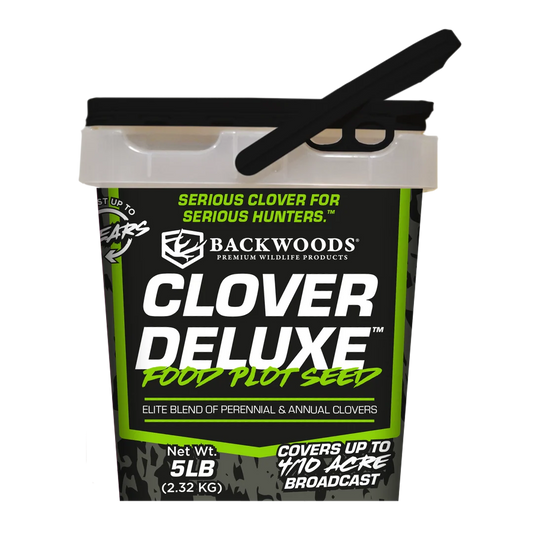 A 5 lb bucket of Backwoods Clover Deluxe Food Plot Seed, featuring a black and green label with a black scoop resting on the lid, set against a plain white background.