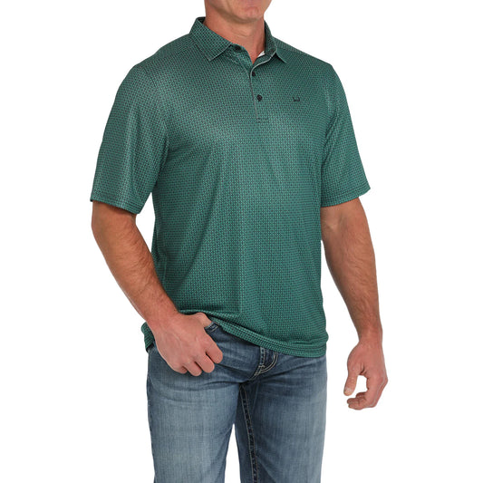 Man wearing green patterned short sleeve polo shirt and blue denim jeans