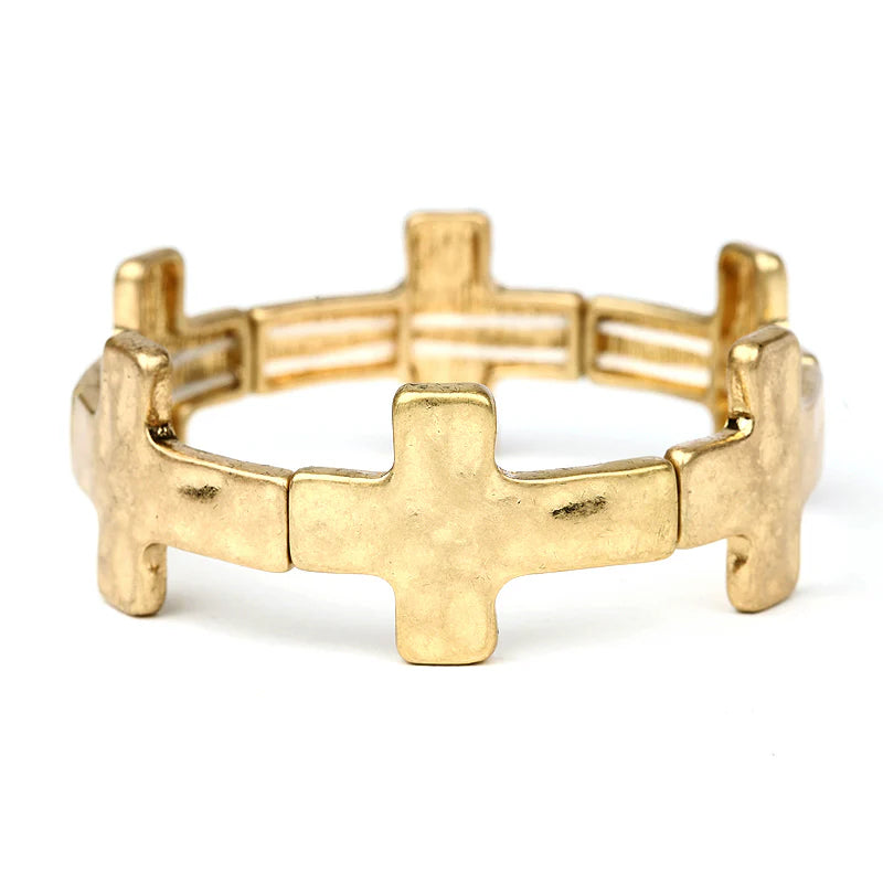 Gold tone cross link stretch bracelet on white background