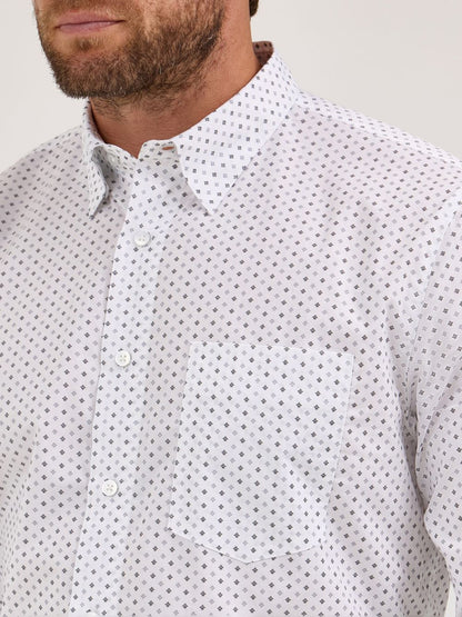 Close-up of a man wearing a white button-up shirt with a grey diamond pattern and front pocket
