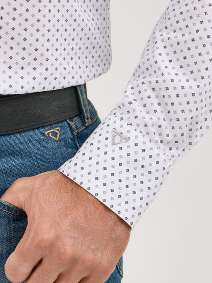 Close-up of man's hand in blue jeans pocket wearing grey patterned long sleeve shirt