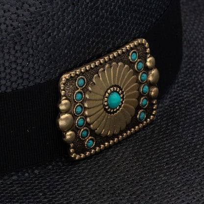 Decorative belt buckle with turquoise stones on a black background