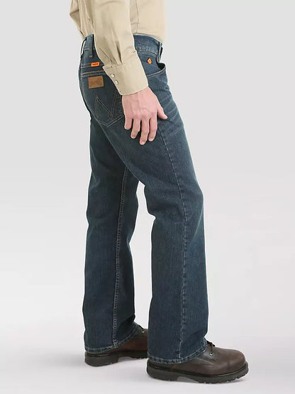 Man wearing blue work jeans with boots, side view, casual workwear style