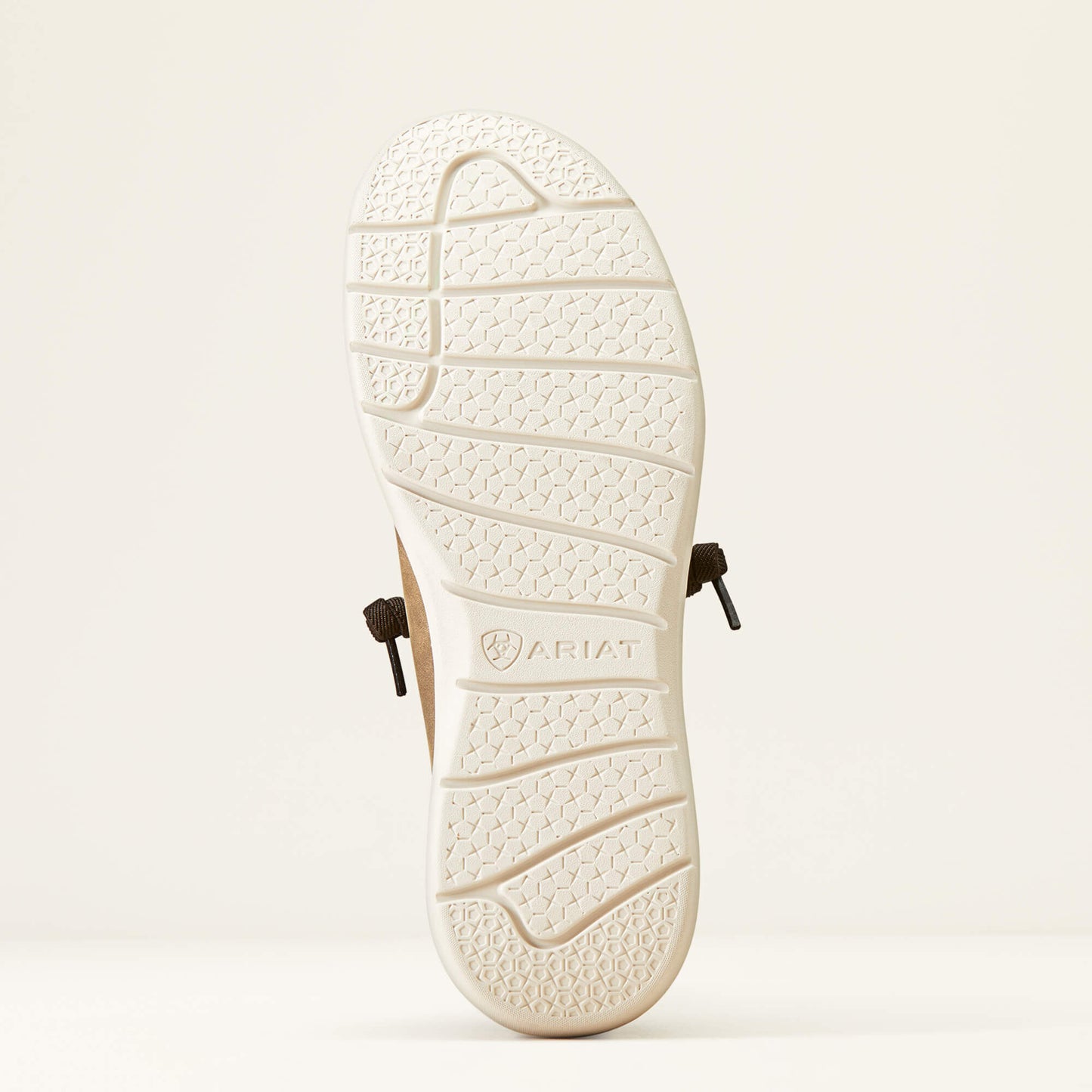 Close-up of Ariat shoe outsole with textured tread and visible brown laces, on white background.