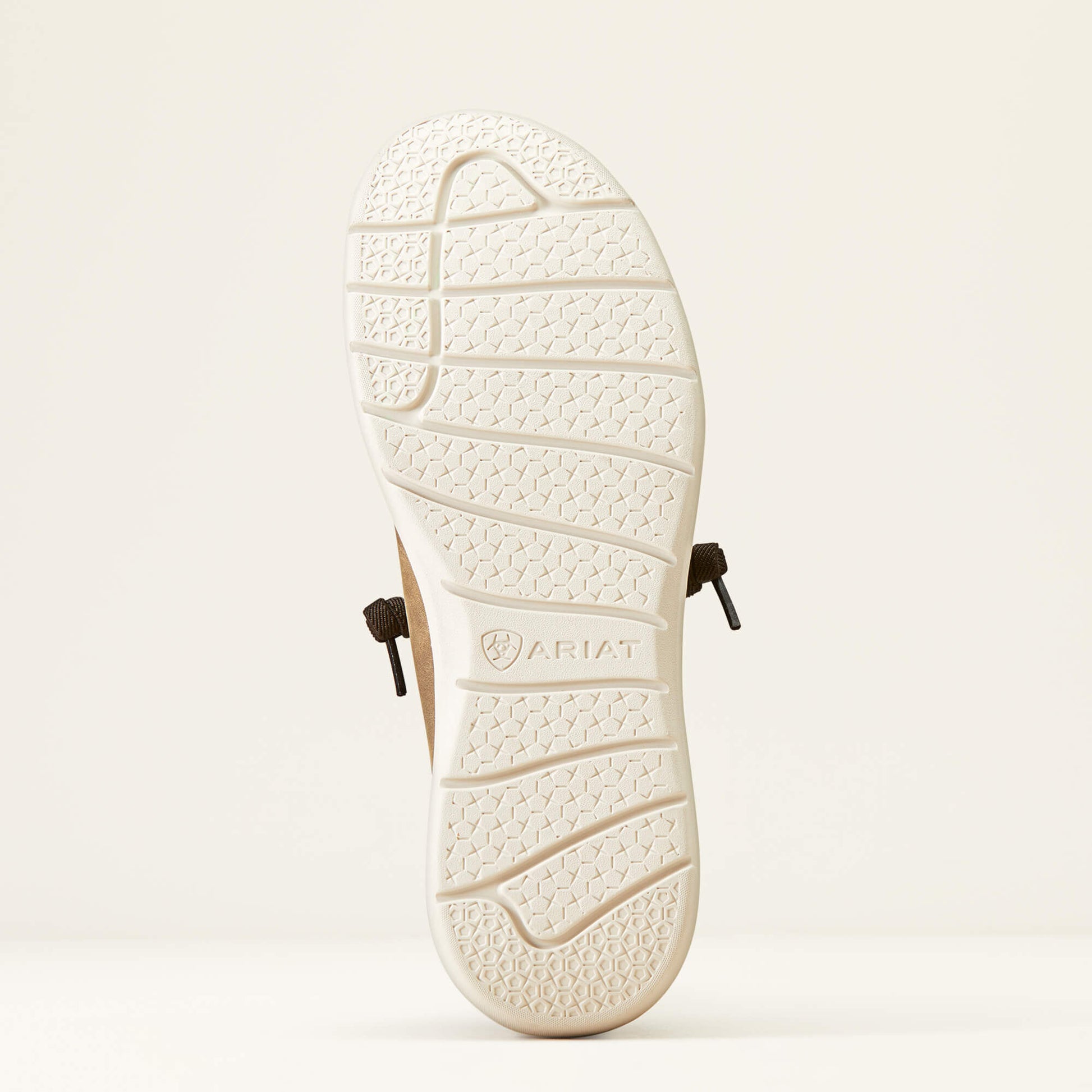 Close-up of Ariat shoe outsole with textured tread and visible brown laces, on white background.