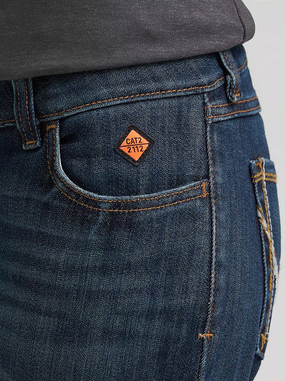 Close-up of blue denim jeans with CAT2 2112 safety patch on front pocket