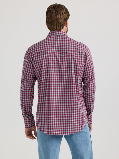 Man wearing red plaid long sleeve shirt and light blue jeans, rear view