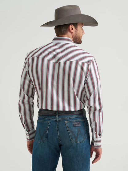 Man in cowboy hat wearing striped western shirt and blue jeans, rear view