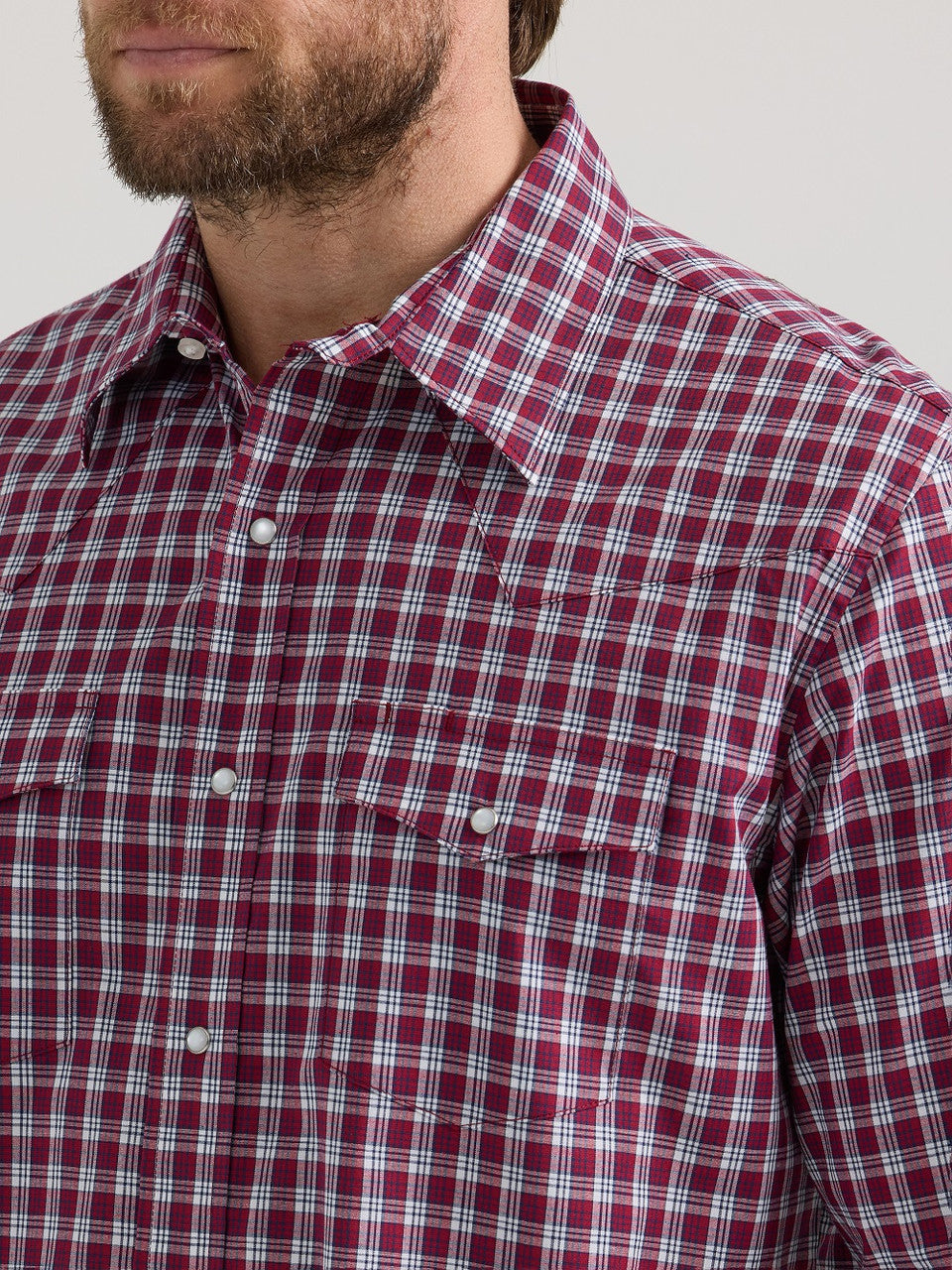 Close-up of man wearing red plaid snap button western shirt with chest pockets