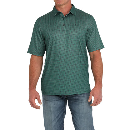 Men's green patterned short sleeve polo shirt paired with blue jeans