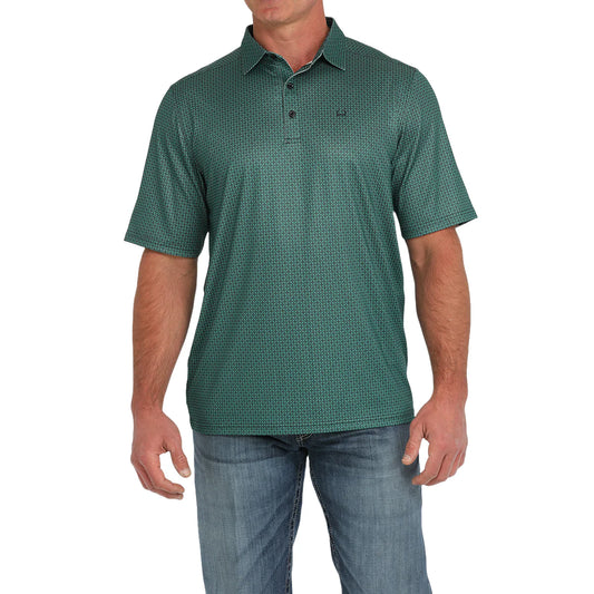 Men's green patterned short sleeve polo shirt paired with blue jeans