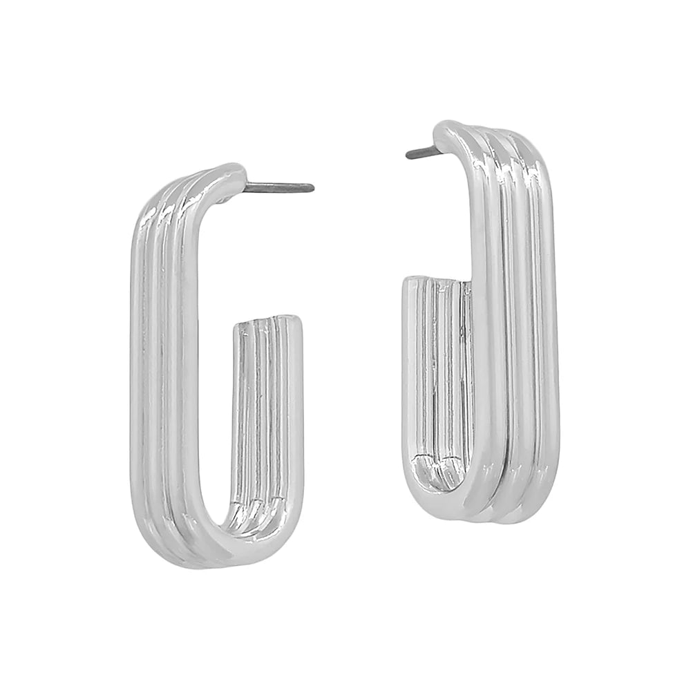 Pair of modern rectangular silver hoop earrings with a ridged design on white background