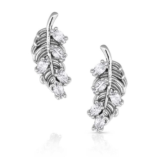 Silver leaf-shaped earrings with clear gemstones on a white background