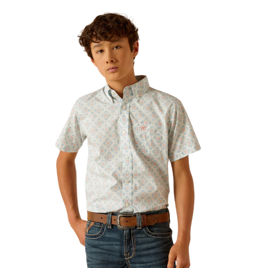 Boy wearing a short-sleeve patterned button-up shirt and jeans