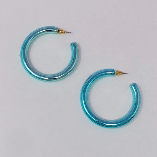 Pair of shiny turquoise hoop earrings with gold posts on a white background