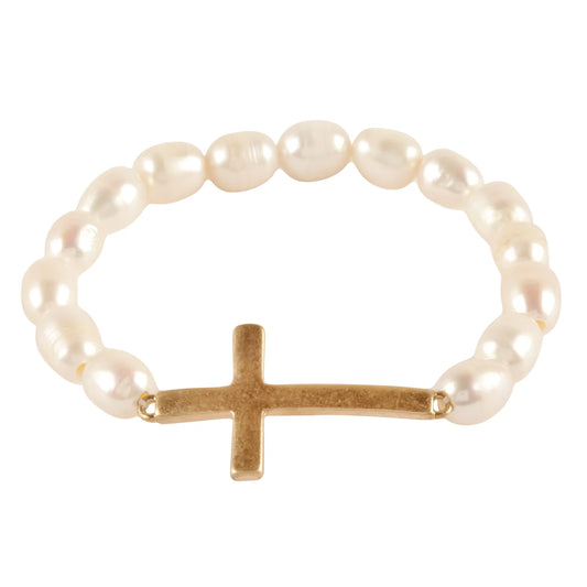 Pearl bracelet with a gold cross on a white background