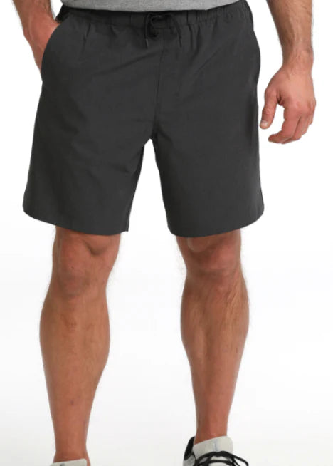 Person wearing dark gray shorts on a white background