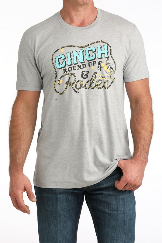 Man wearing a gray t-shirt with 'Ginch Round Up & Rodeo' graphic design.