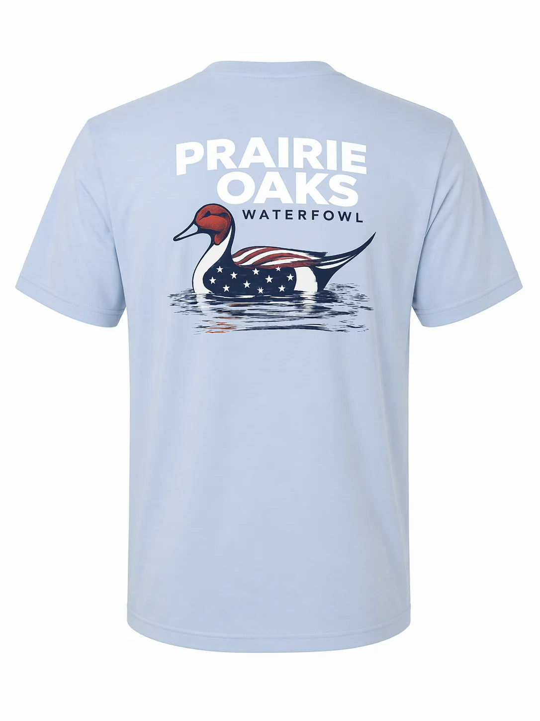 A light blue short-sleeve t-shirt shown from the back, featuring a large graphic of a waterfowl duck with an American flag pattern and the text 'PRAIRIE OAKS WATERFOWL' printed above it.