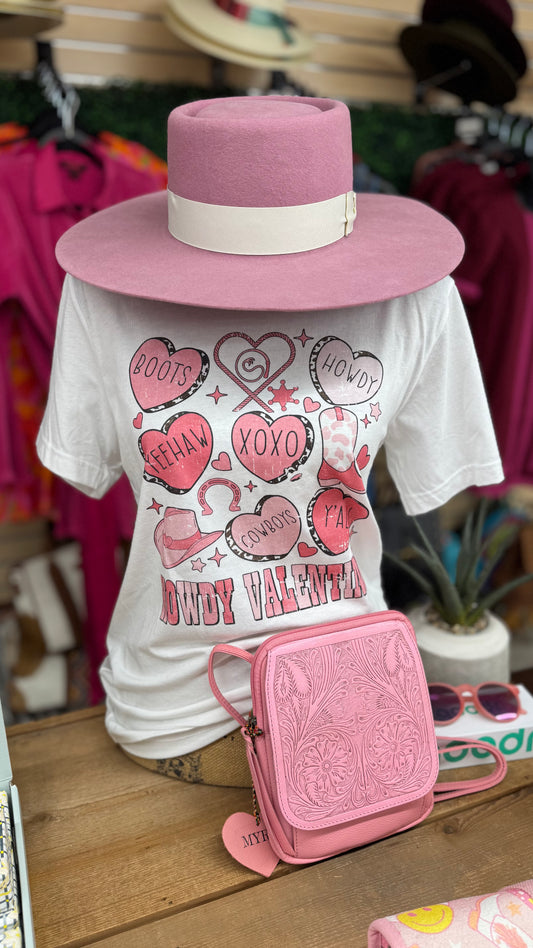 Pink wide-brim hat, Valentine western graphic tee, and embossed pink crossbody purse display