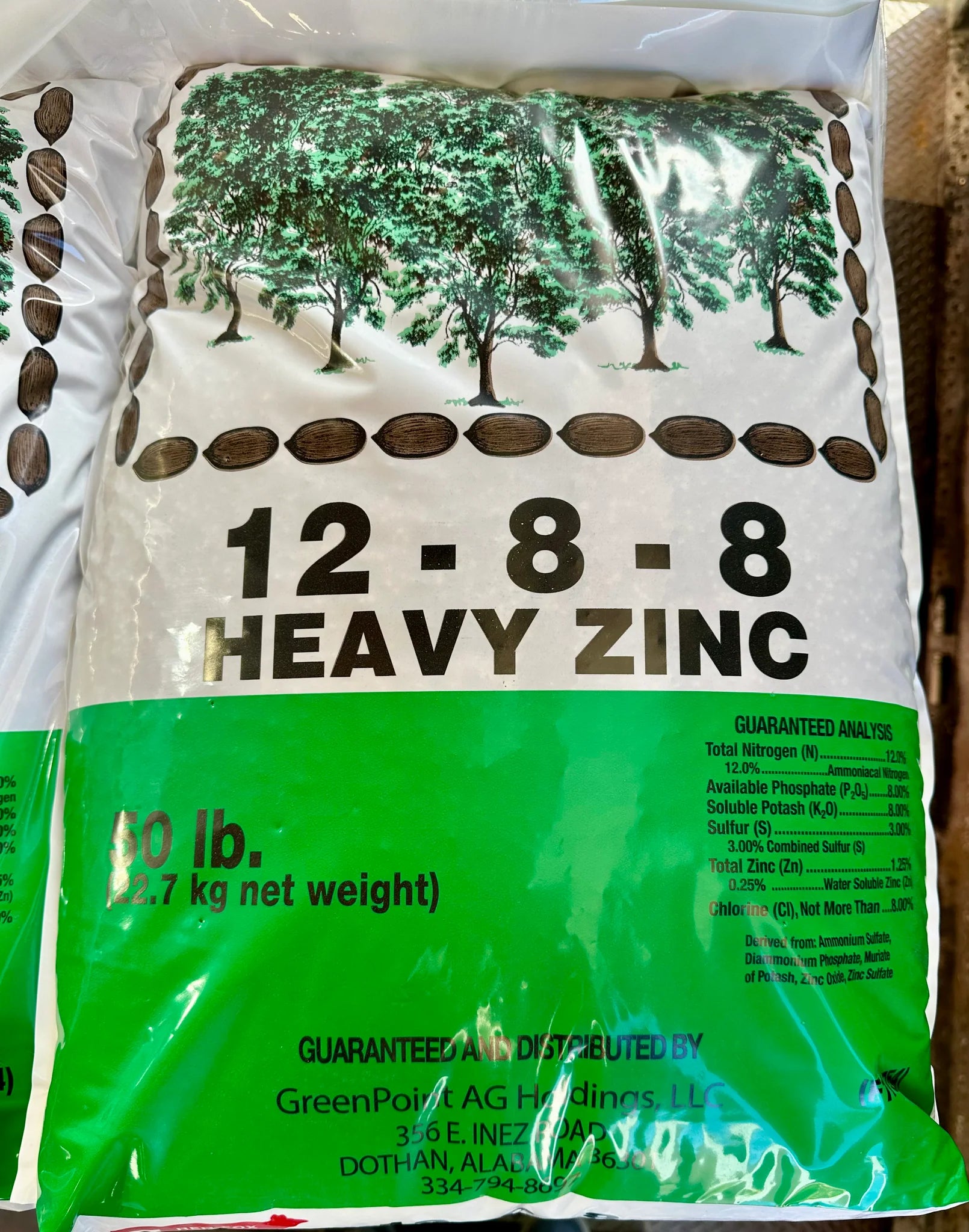 Fertilizer bag with '12-8-8 Heavy Zinc' label on a white background