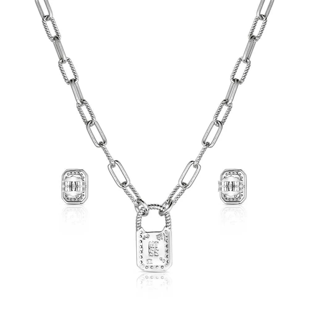 Silver chain necklace with rectangular pendant and matching stud earrings on white background