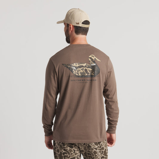 Man wearing brown long sleeve shirt with duck graphic and camo pants, outdoor apparel.