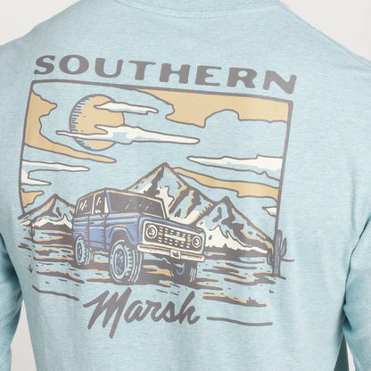 Light blue graphic t-shirt with vintage SUV, desert mountains, sun, and cactus design