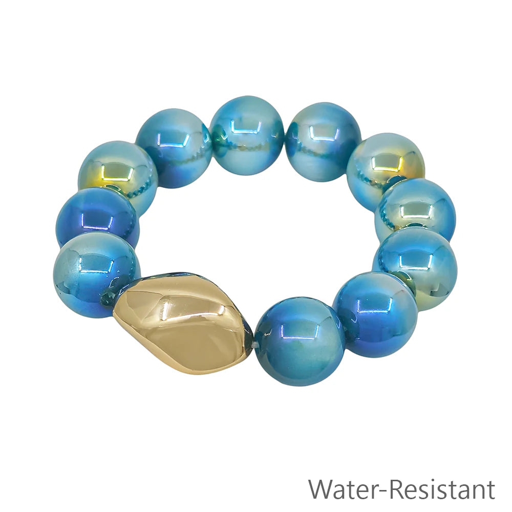 Blue beaded stretch bracelet with large gold accent, water-resistant jewelry