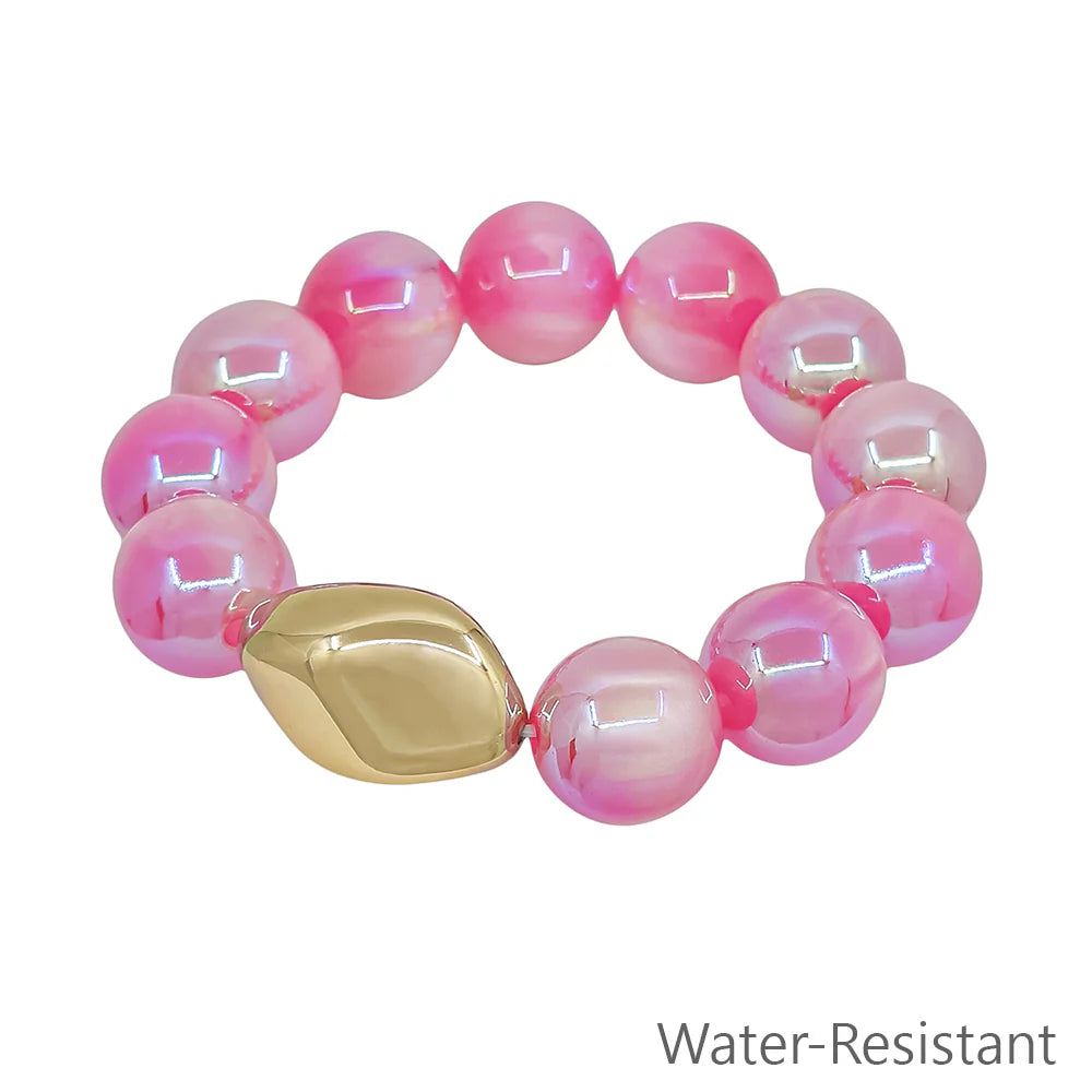 Pink beaded stretch bracelet with shiny gold accent bead, water-resistant jewelry