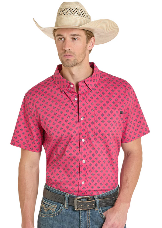 Man wearing a pink patterned shirt, blue jeans, and a straw cowboy hat on a white background